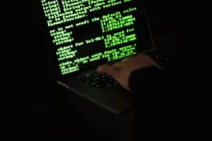 Green lines of code on a dark screen, illustrating Microsoft AI agent controls and security monitoring