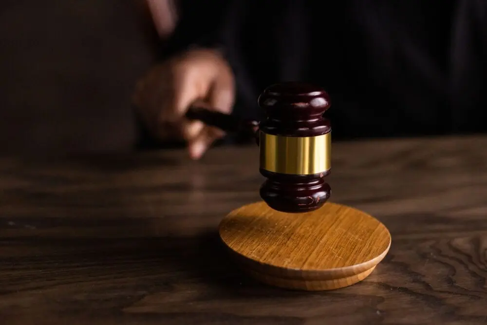A judge's gavel striking a sound block, illustrating the OpenAI lawsuit filed by eight states