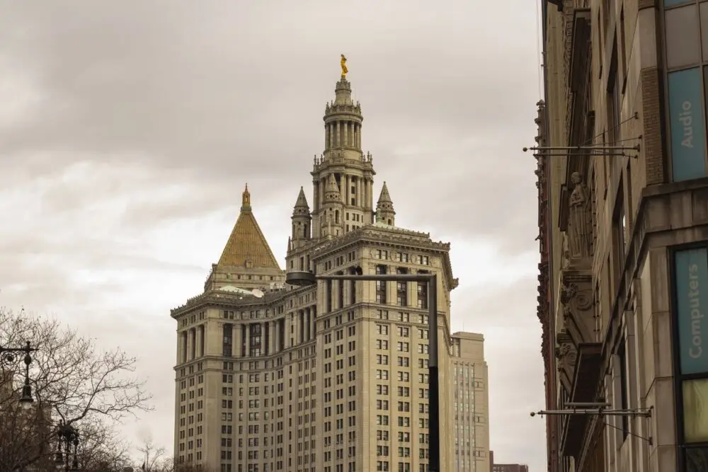 Manhattan Municipal Building under a cloudy sky, as the Grok NYC Council hearing looks ahead