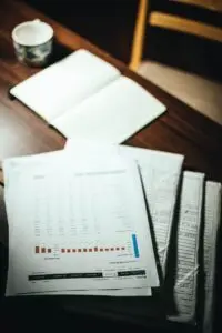 Financial documents and spreadsheets spread on a desk, representing private credit redemptions paperwork