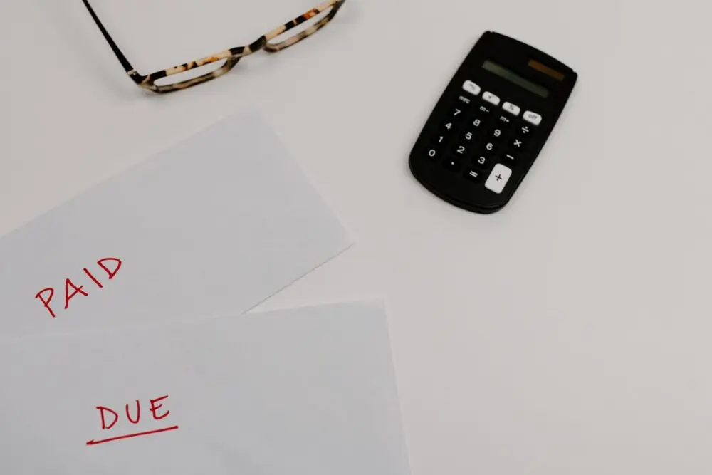 Handwritten paid and due labels on paper, a reminder to follow up when you create an invoice