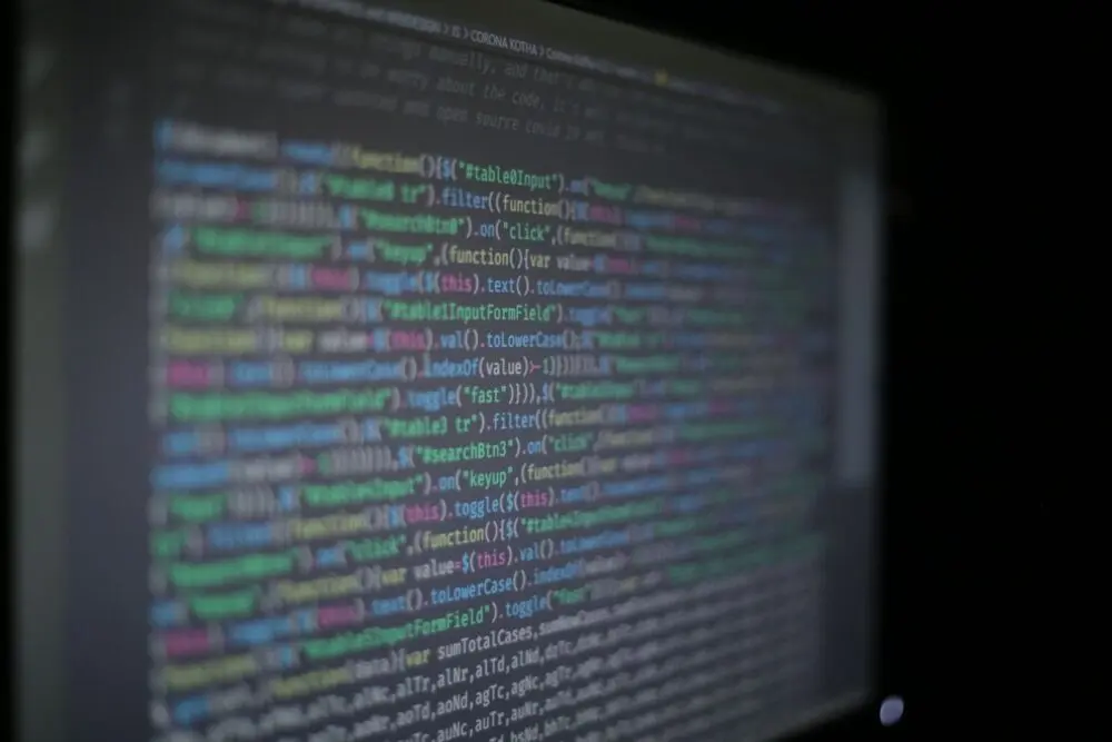 Lines of code on a dark screen, representing the data Varonis maps and protects