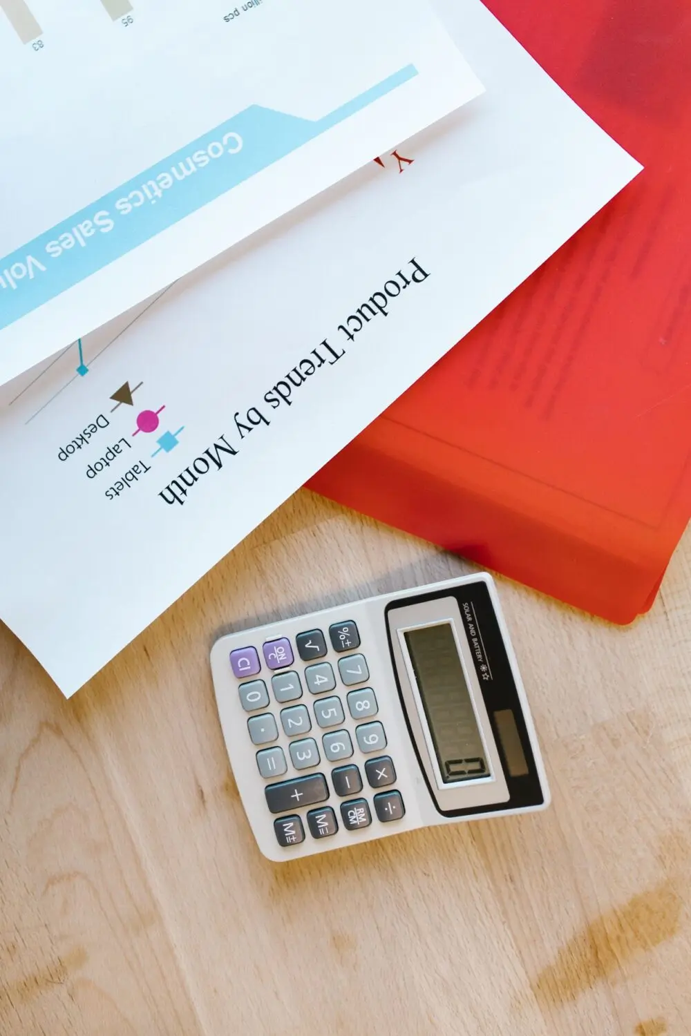 A calculator on top of printed charts, used to compare premiums during ACA open enrollment