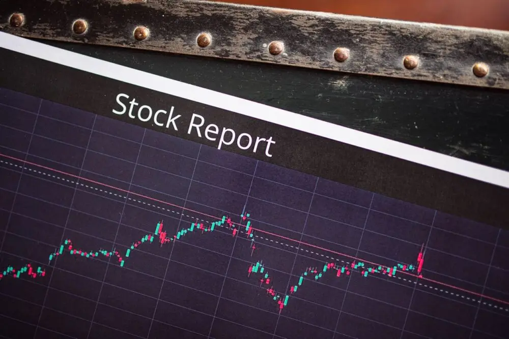 Close-up of a printed stock report with a market performance graph