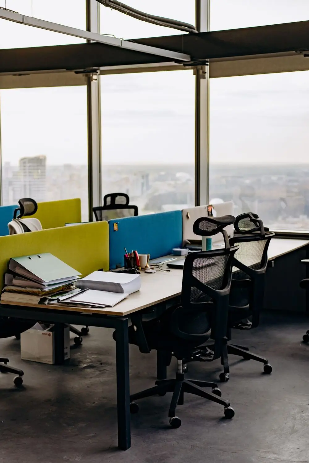 Office desks beside tall windows, a scene from the week of October layoffs