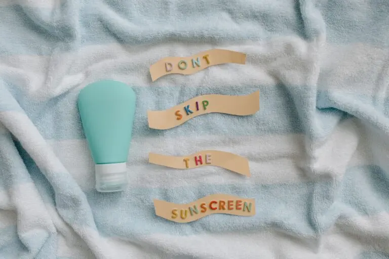 Sunscreen bottle and towel, illustrating bemotrizinol sunscreen