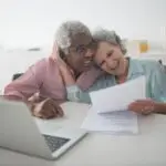 Senior couple reviewing documents together at a desk, illustrating choosing a Medicare Advantage plan
