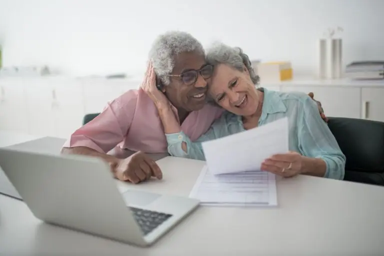Senior couple reviewing documents together at a desk, illustrating choosing a Medicare Advantage plan