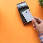 A contactless card payment at a terminal, illustrating what payments earnings reveal about spending