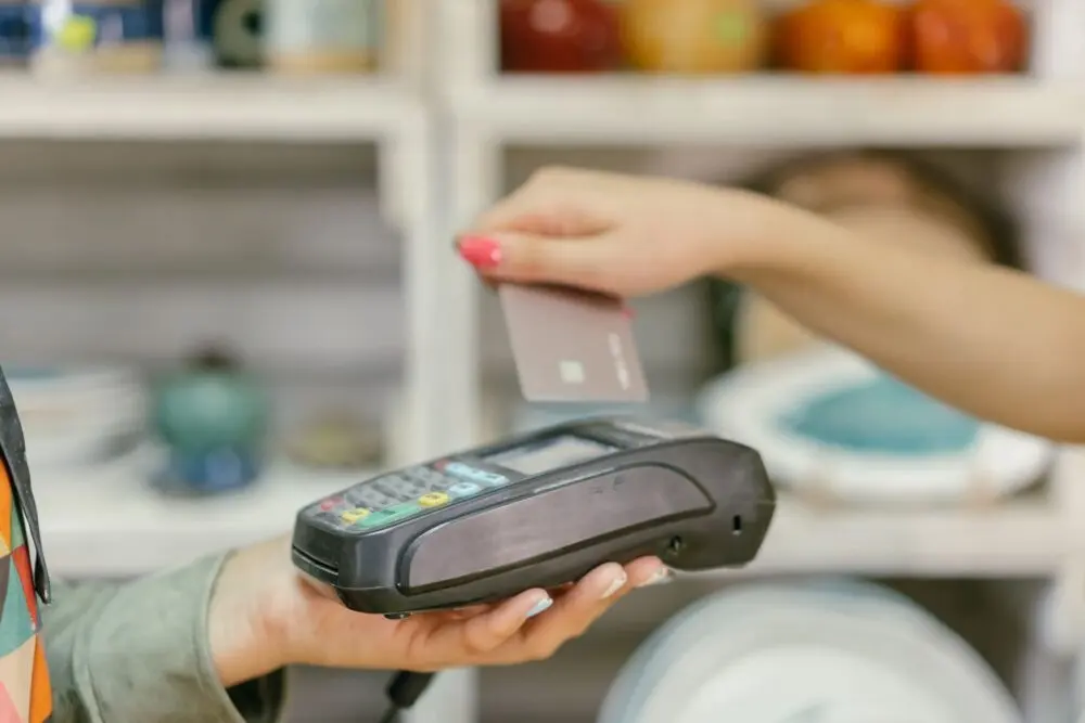 Hand holding a payment terminal for a card transaction