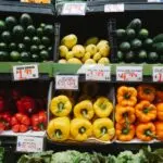 Supermarket produce shelves with peppers, squash and cucumbers, illustrating the Sprouts earnings story